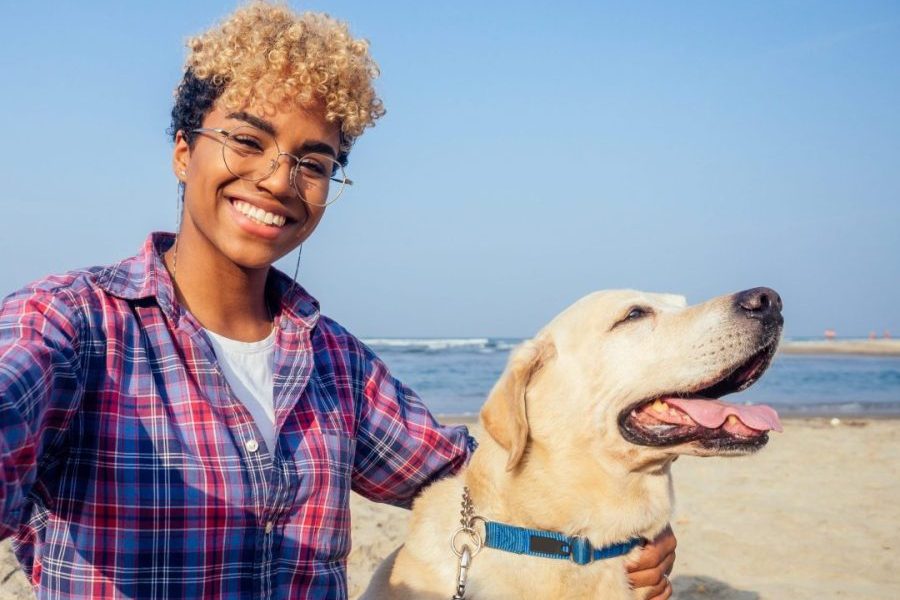 woman-with-dog-on-beach